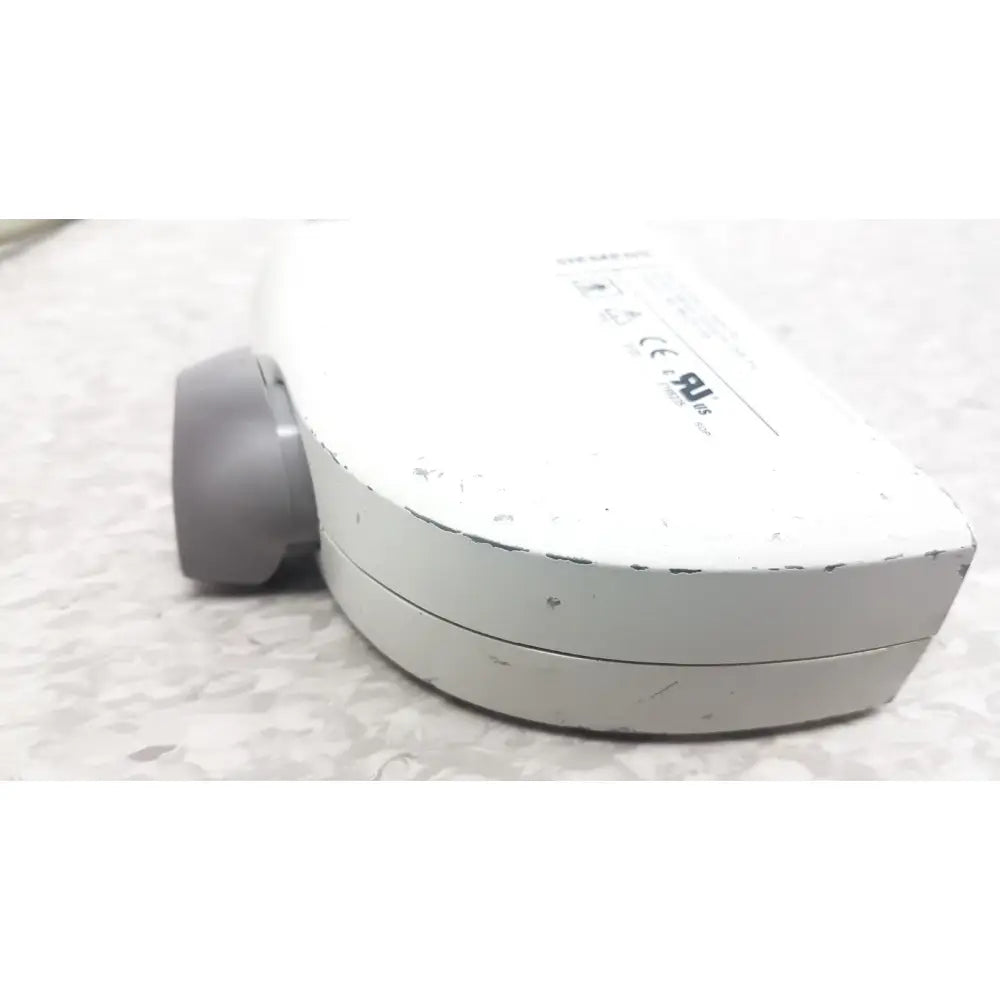 White plastic siemens ev9-4 endocavity ultrasound transducer probe with gray circular component and visible wear and chipped paint