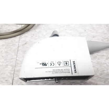 White siemens ev9-4 endocavity ultrasound transducer probe housing with gray cable connections and regulatory labels shown from back side