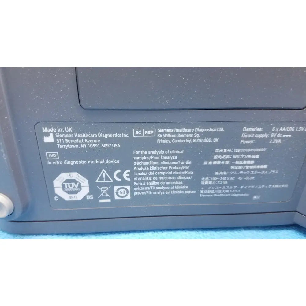 Gray plastic medical device label with black text and certification logos on siemens healthcare clinitek status analyzer