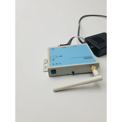 Light gray rectangular serial server with blue panel and gold antenna by silex technologies sx-500 with labeled ports