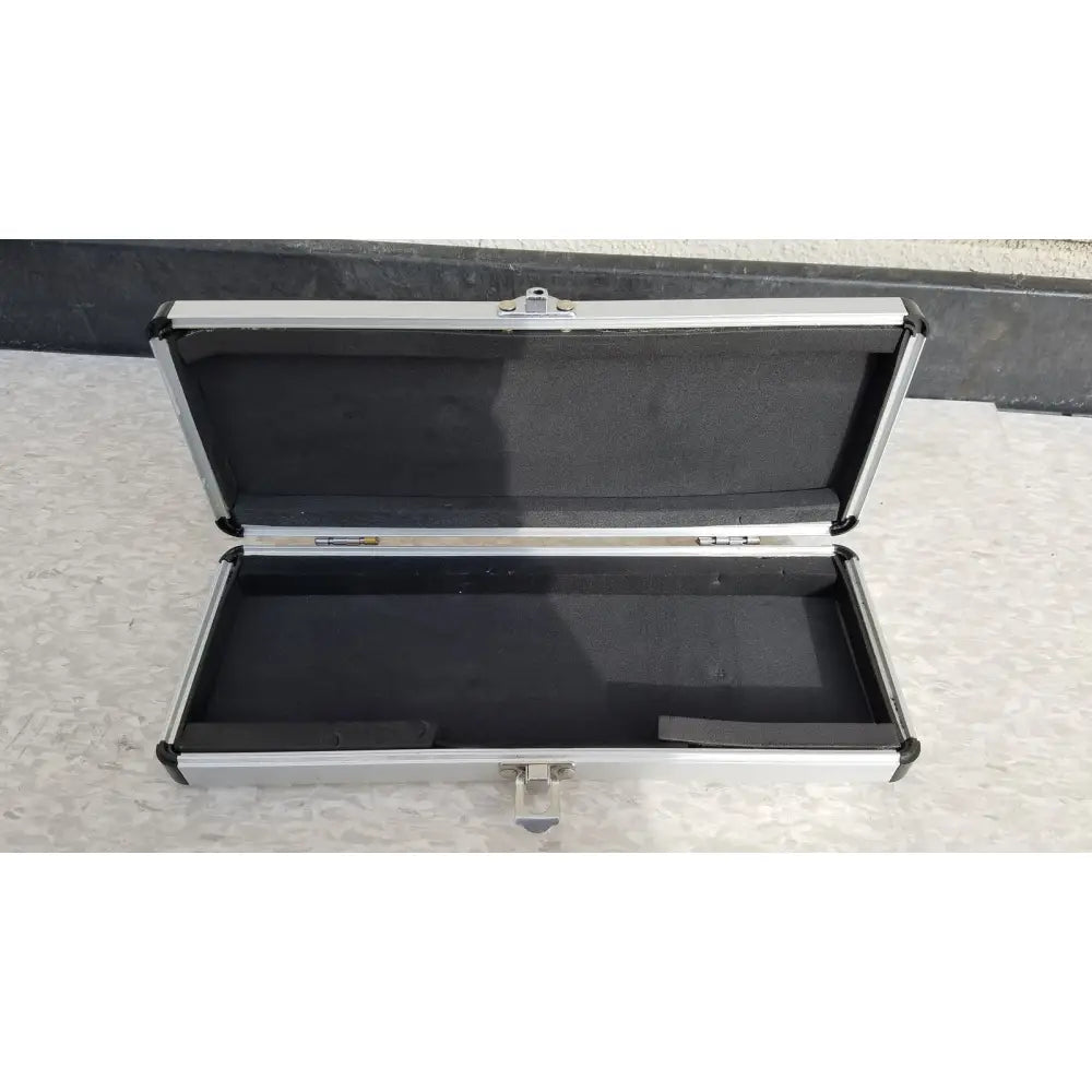 Silver hard protective aluminum instrument case with black foam interior for secure storage and transport