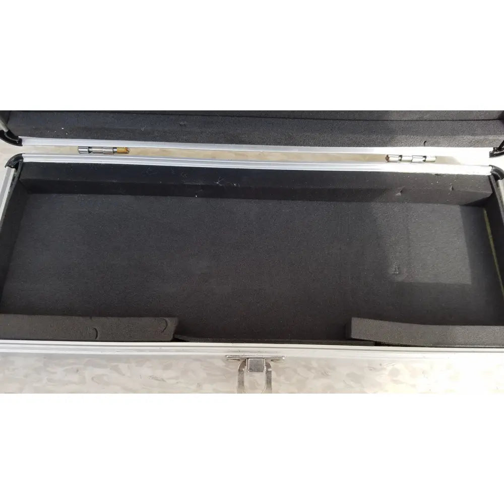Silver hard protective aluminum keyboard case with black foam interior and molded compartments for secure storage