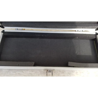 Silver hard protective aluminum keyboard case with black foam interior and molded compartments for secure storage