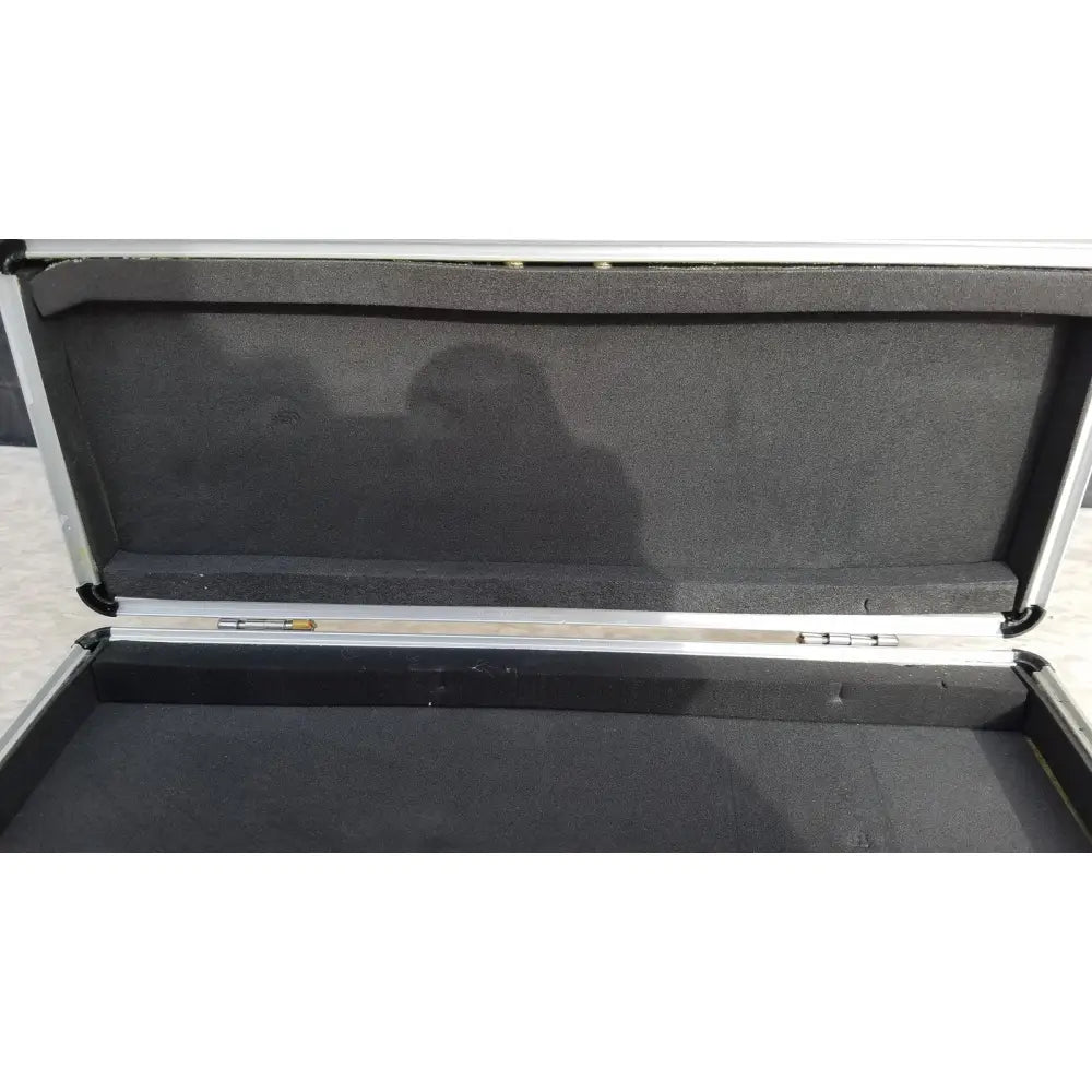 Silver hard protective flight case with aluminum exterior and black foam interior for secure equipment storage