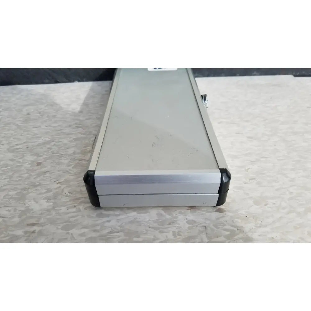 Silver hard protective aluminum tool case with black rubberized corners and side latch for secure storage