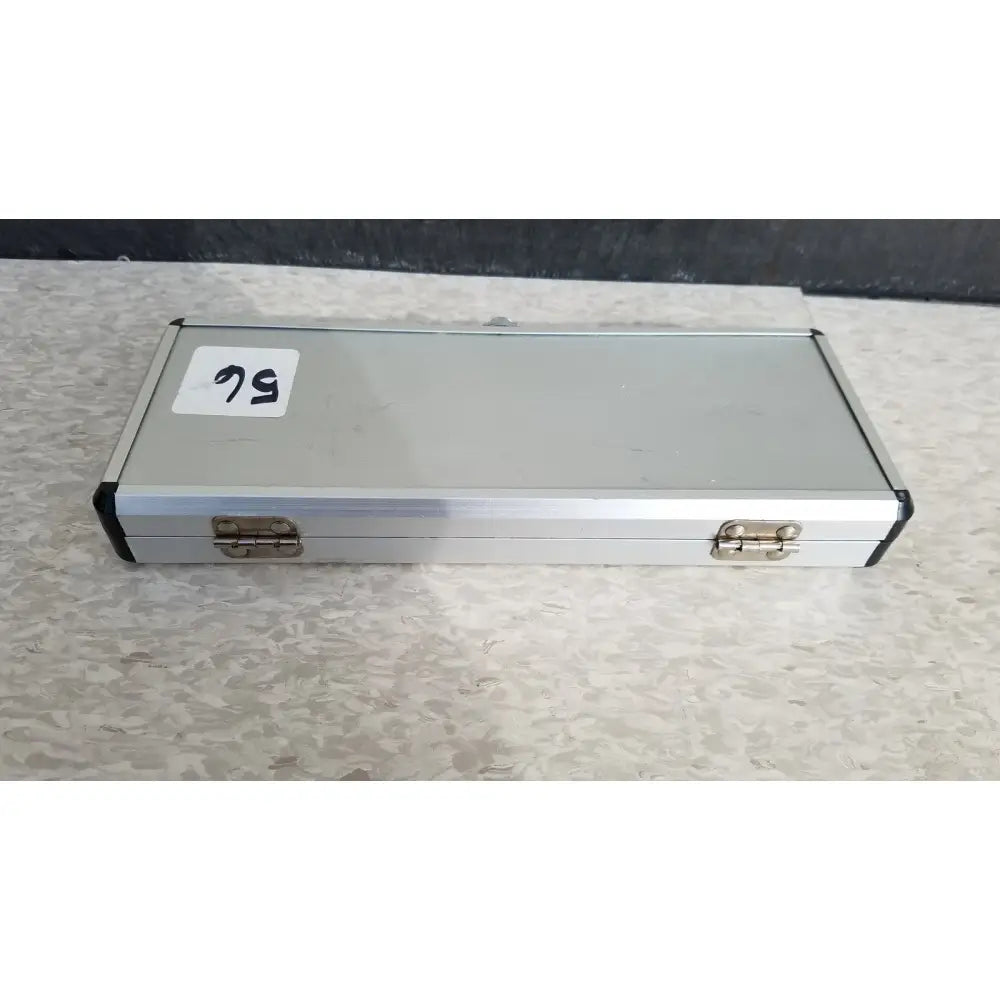 Silver hard protective aluminum case with black corner accents and brass latches for secure storage