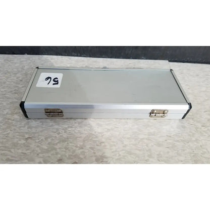 Silver hard protective aluminum case with black corner accents and brass latches for secure storage