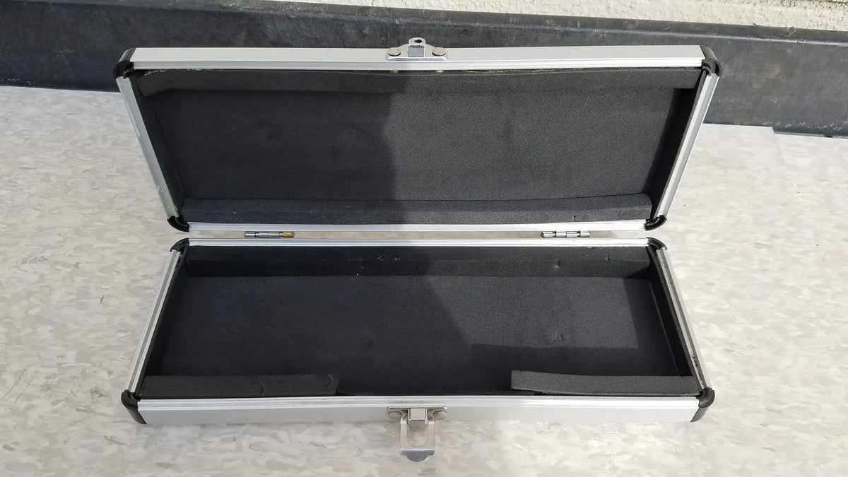 Silver hard protective aluminum instrument case with black foam interior for secure storage and transport