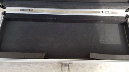 Silver hard protective aluminum keyboard case with black foam interior and molded compartments for secure storage