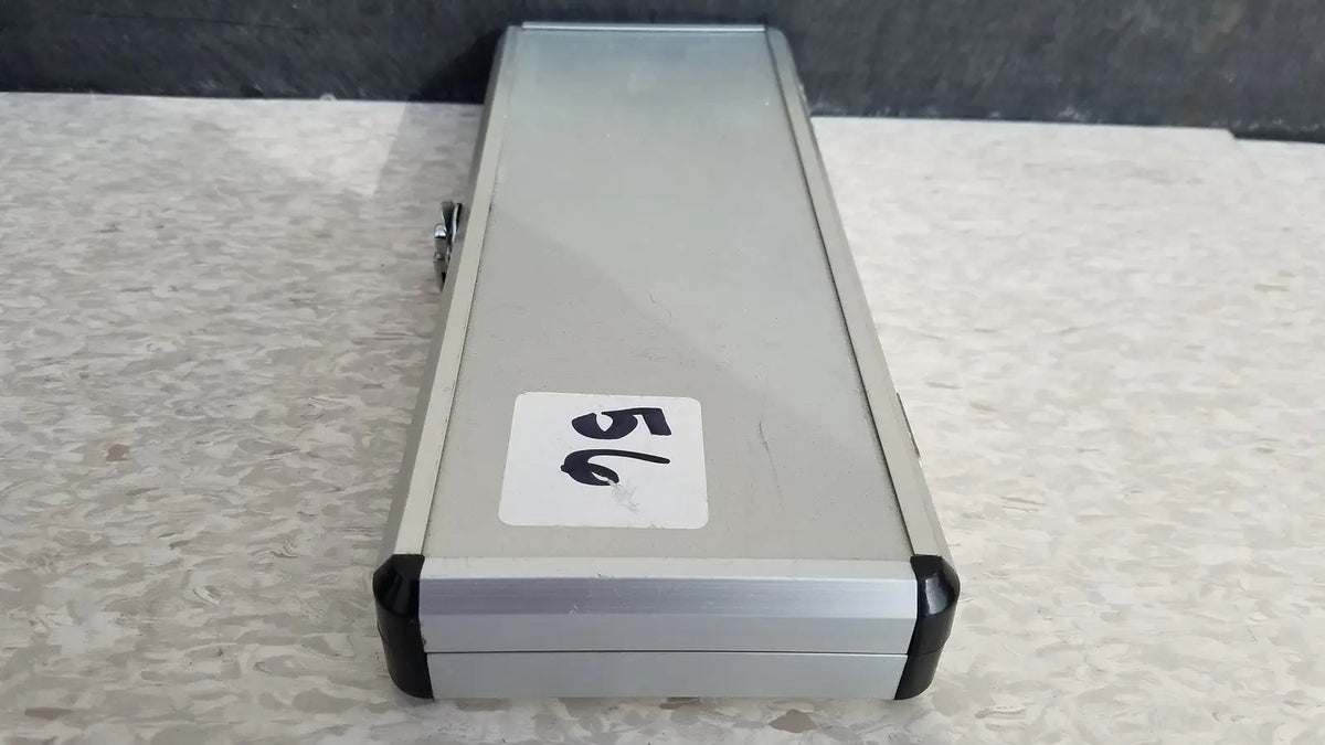 Silver hard protective case with black plastic corners and white number 56 sticker on the back side