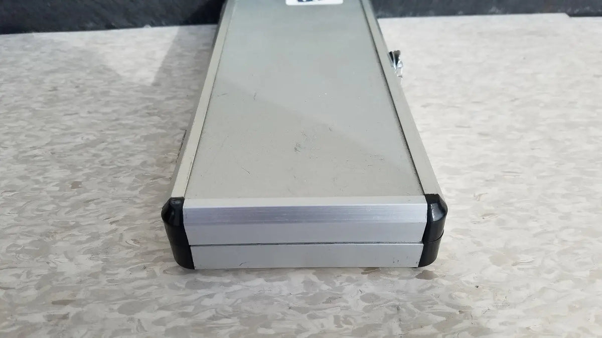 Silver hard protective aluminum tool case with black rubberized corners and side latch for secure storage