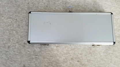 Silver hard protective aluminum tool case with black corner accents and a small transparent latch