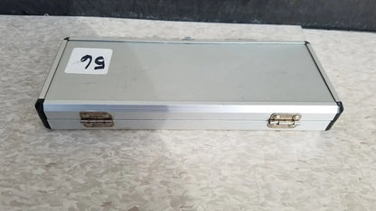 Silver hard protective aluminum case with black corner accents and brass latches for secure storage