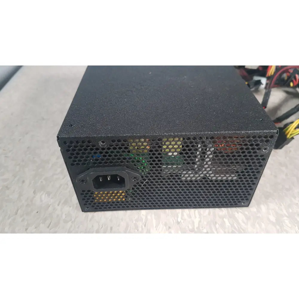Black perforated metal silverstone 1200w strider gold power supply with visible internals and iec connector