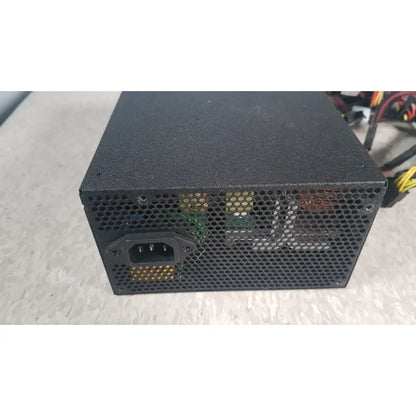 Black perforated metal silverstone 1200w strider gold power supply with visible internals and iec connector