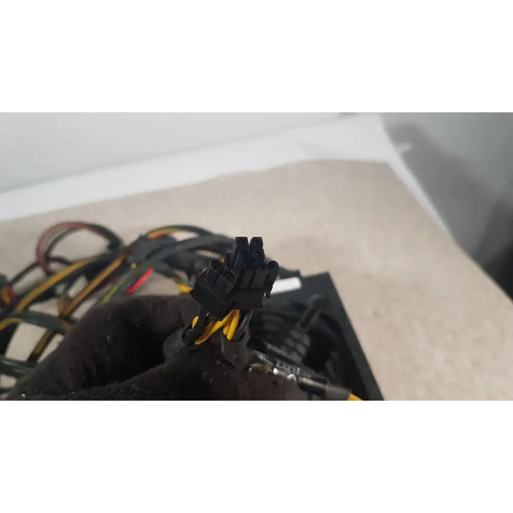 Black plastic power supply connector with yellow and black cables on the back of silverstone 1200w strider gold power supply