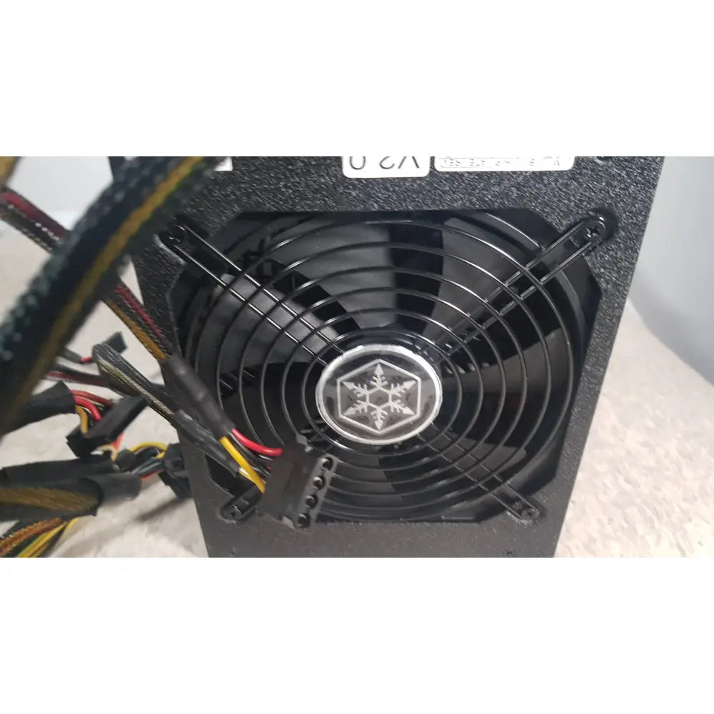 Black silverstone 1200w strider gold power supply unit with circular fan and silver snowflake logo at center