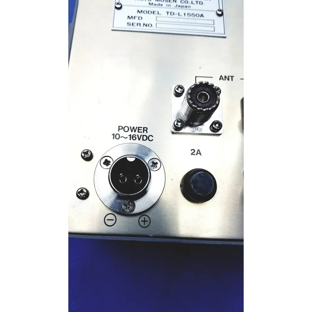 Silver metallic control panel on the back side of simrad taiyo synthesized vhf automatic digital direction finder with labeled inputs