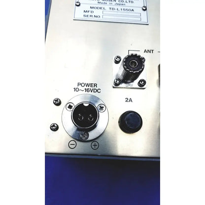 Silver metallic control panel on the back side of simrad taiyo synthesized vhf automatic digital direction finder with labeled inputs