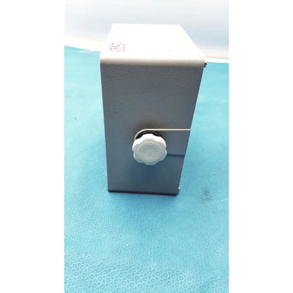 Gray rectangular metal box with white textured knob on front simrad taiyo synthesized vhf automatic digital direction finder
