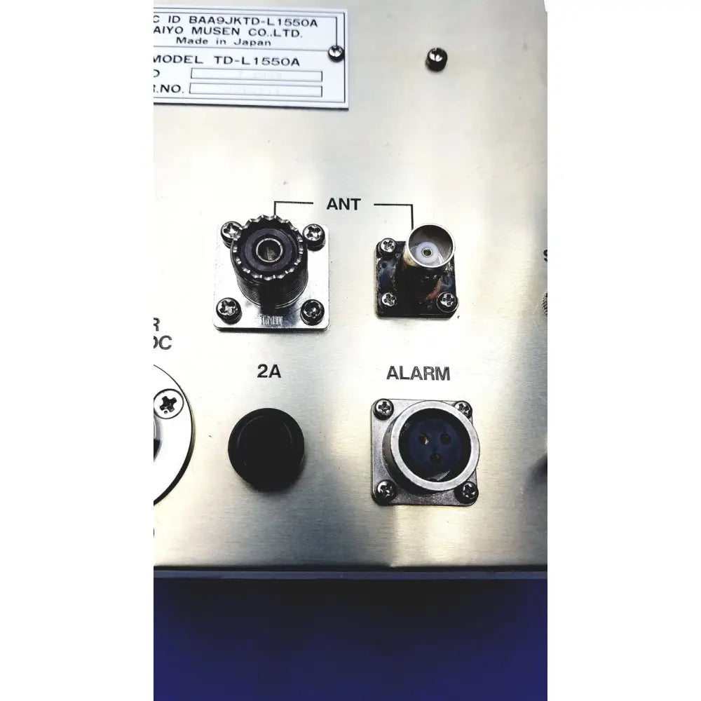 Back side of silver metallic simrad taiyo synthesized vhf automatic digital direction finder with labeled connectors and model plate