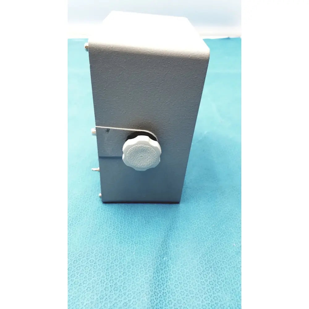 Gray rectangular metal Simrad Taiyo synthesized vhf automatic digital direction finder with a white textured front knob