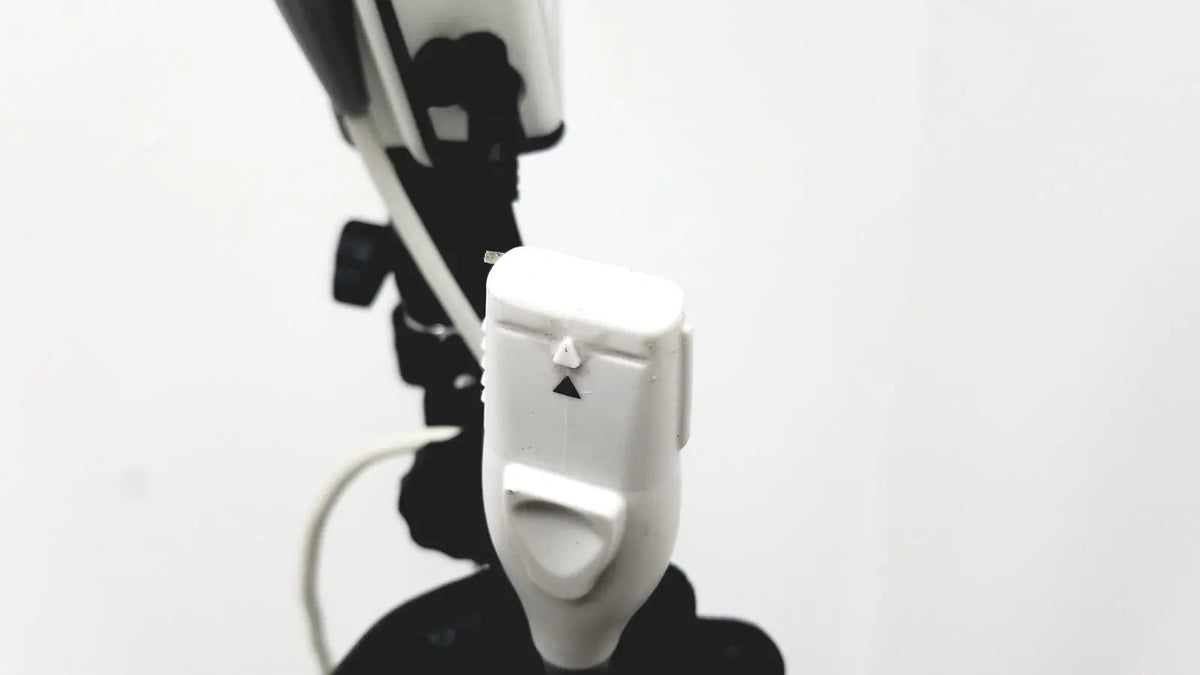 White plastic camera remote shutter release with black triangular buttons for site rite prevue ultrasound system use