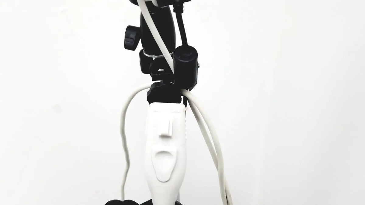 White electric toothbrush with black mounting hardware and cords attached to site rite prevue ultrasound system cart
