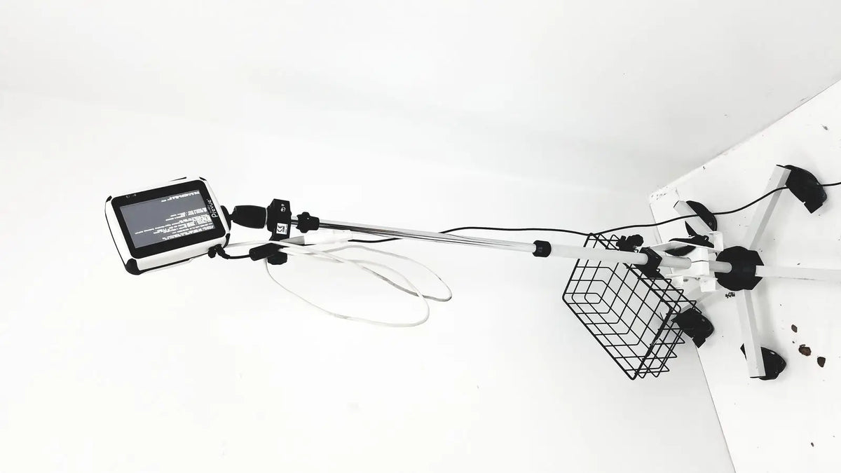 White tablet mounted on telescopic pole with wire basket on base in site rite prevue ultrasound rolling cart system
