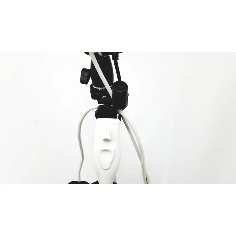White electric toothbrush with black mounting hardware and cords attached to site rite prevue ultrasound system cart