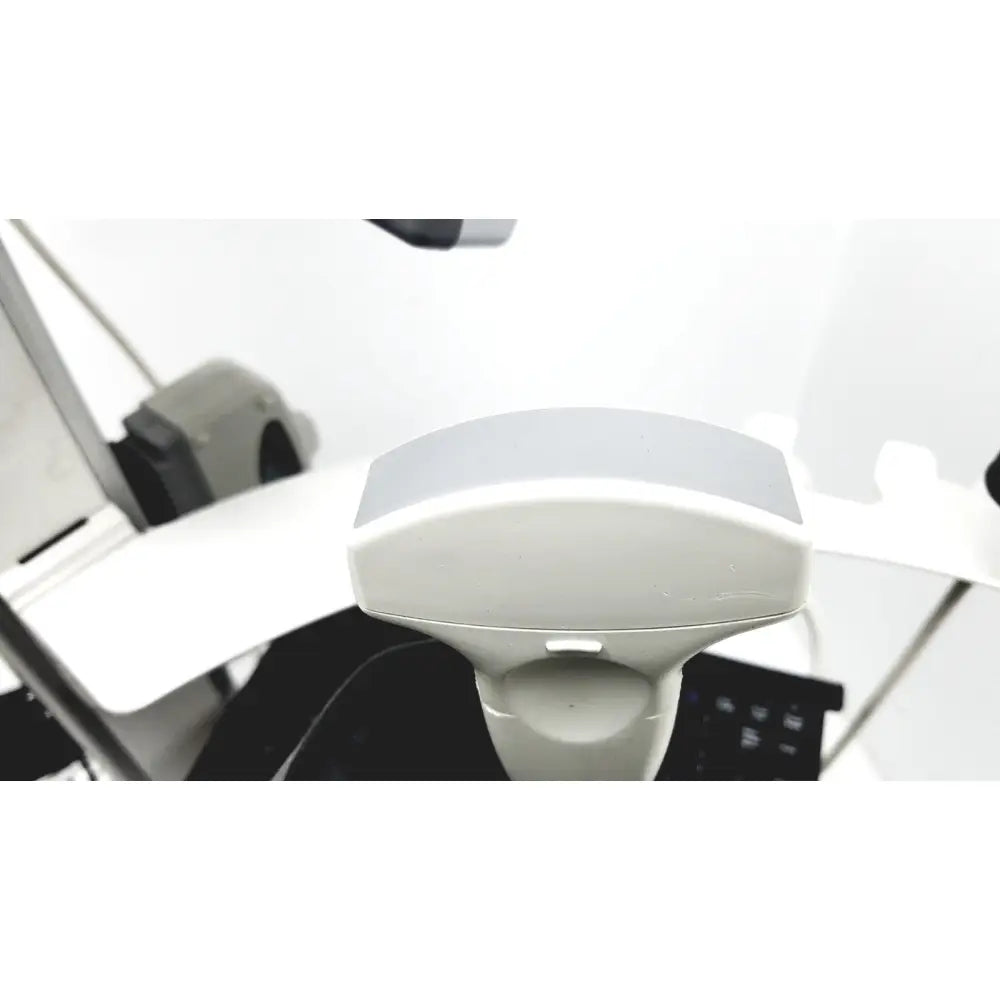 White plastic site rite vision ultrasound device with curved top and small rectangular front button on rolling cart extras