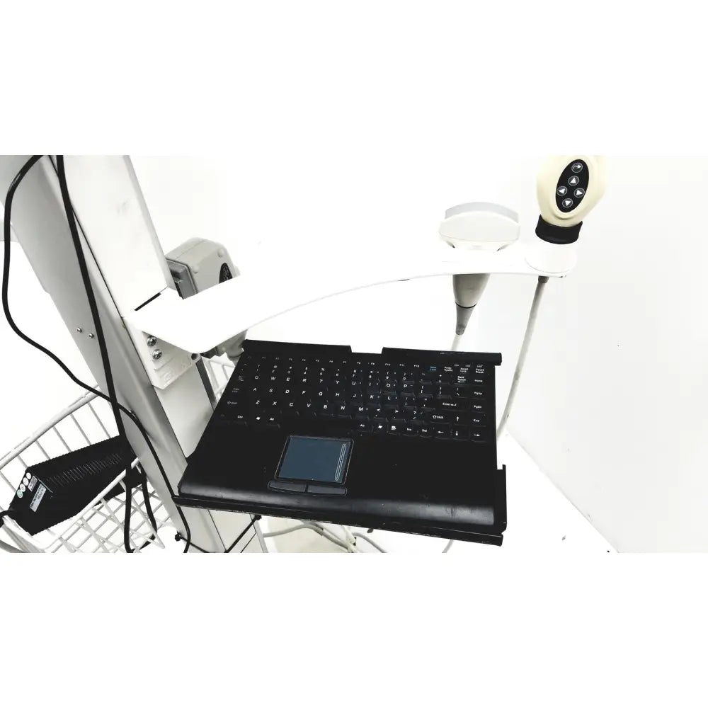 Black laptop with integrated touchpad and keyboard on white adjustable desk mount of site rite vision ultrasound system