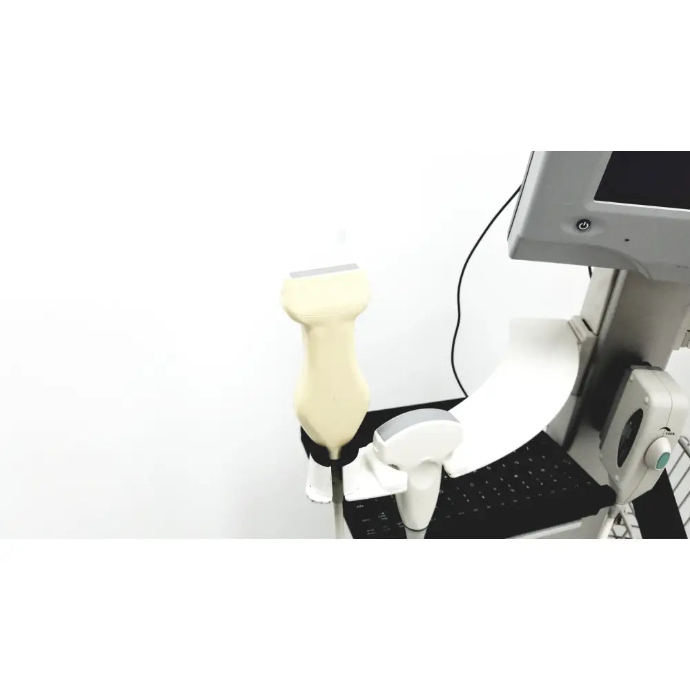 Cream-colored site rite vision ultrasound transducer with smooth ergonomic grip and rounded head on rolling cart with extras