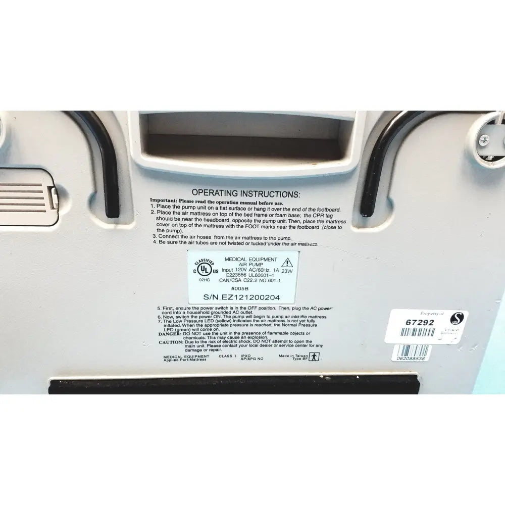White plastic sizewise medical equipment air pump with black rubber hoses and label showing model and serial numbers