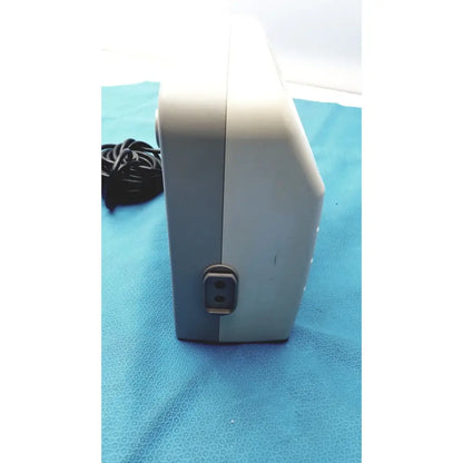 Gray and white rectangular sizewise medical equipment air pump with power input port on the side for medical equipment use