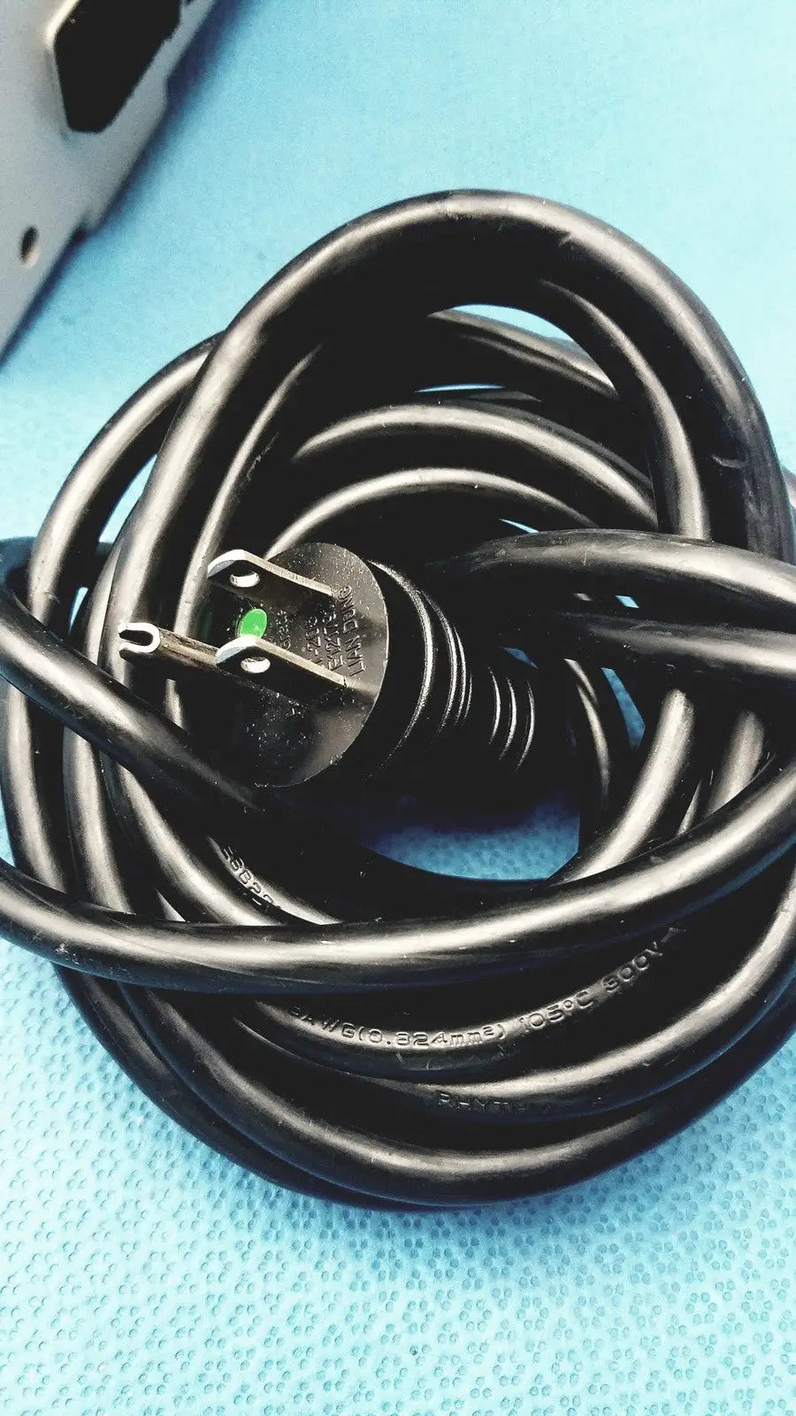 Black coiled power cord with three-prong plug and green grounding pin for sizewise medical equipment air pump