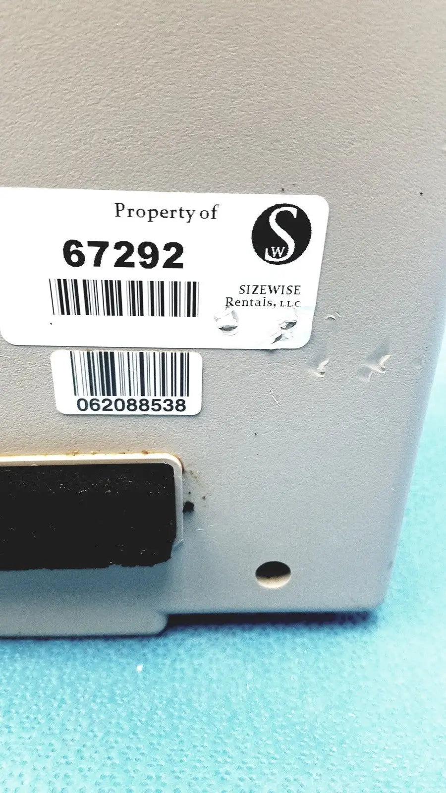 Gray metallic sizewise medical equipment air pump with black magnetic strip and two white rental labels from sizewise rentals llc