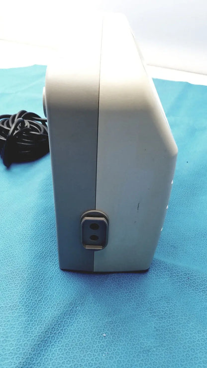 Gray and white rectangular sizewise medical equipment air pump with power input port on the side for medical equipment use