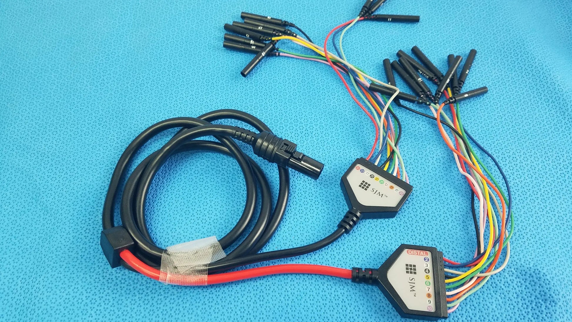 Black coiled SJM St Jude Medical diagnostic connection cable with hexagonal connectors and multi-colored wires for reuse medical equipment