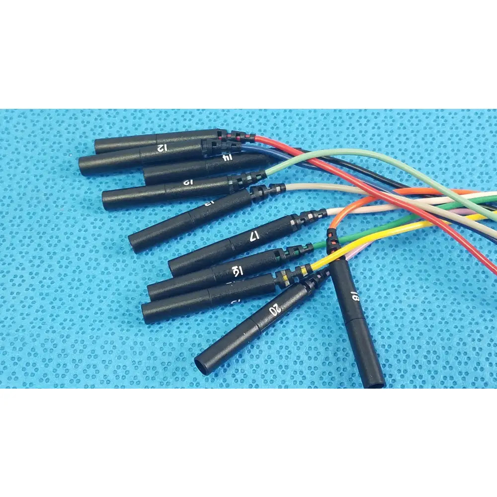 Black ignition coils with numbered markings and colorful wiring on the back side of sjm st jude medical diagnostic connection cable for reuse medical equipment