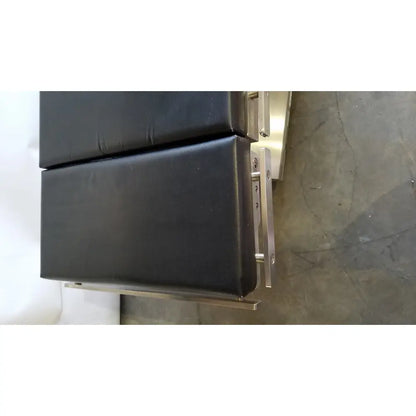 Skytron 1700 surgical table with hand control features black padded top and stainless steel frame for reuse medical settings