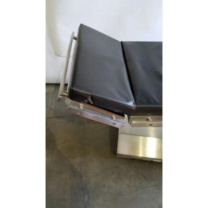 Skytron 1700 surgical table with black leather top stainless steel frame and hand control for reuse medical settings