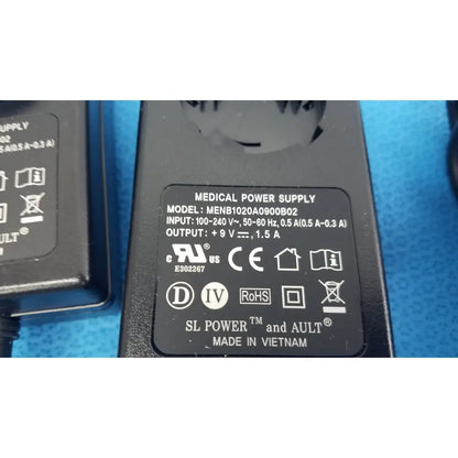 Black plastic medical power supply menb1020a0900b02 with 9v 1.5a output and ul ce certifications on label