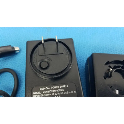 Black plastic medical power supply menb1020a0900b02 with two prongs and circular dial for medical equipment use