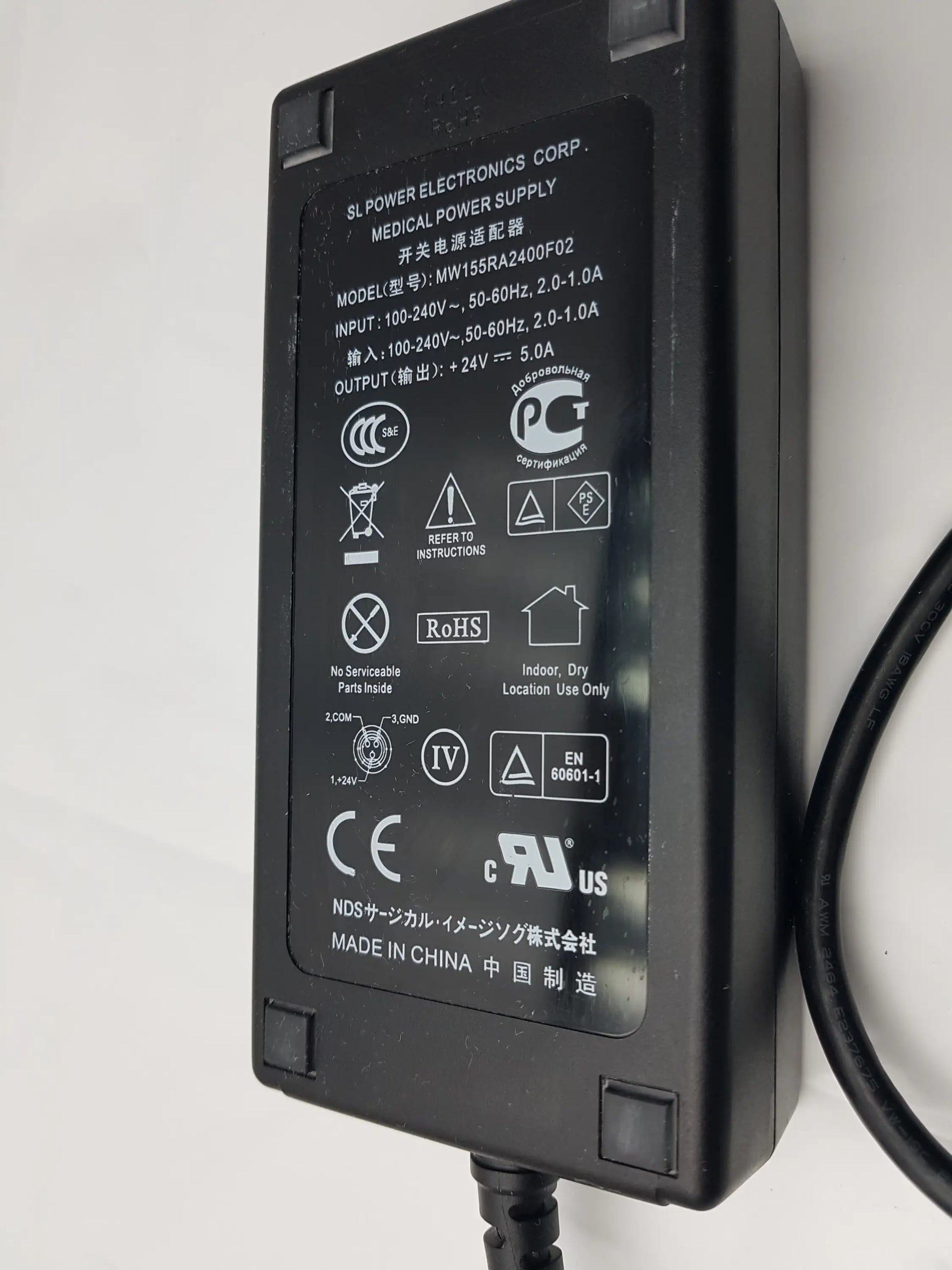 Black plastic medical power supply mw155ra2400f02 with matte finish and printed specifications on label back side