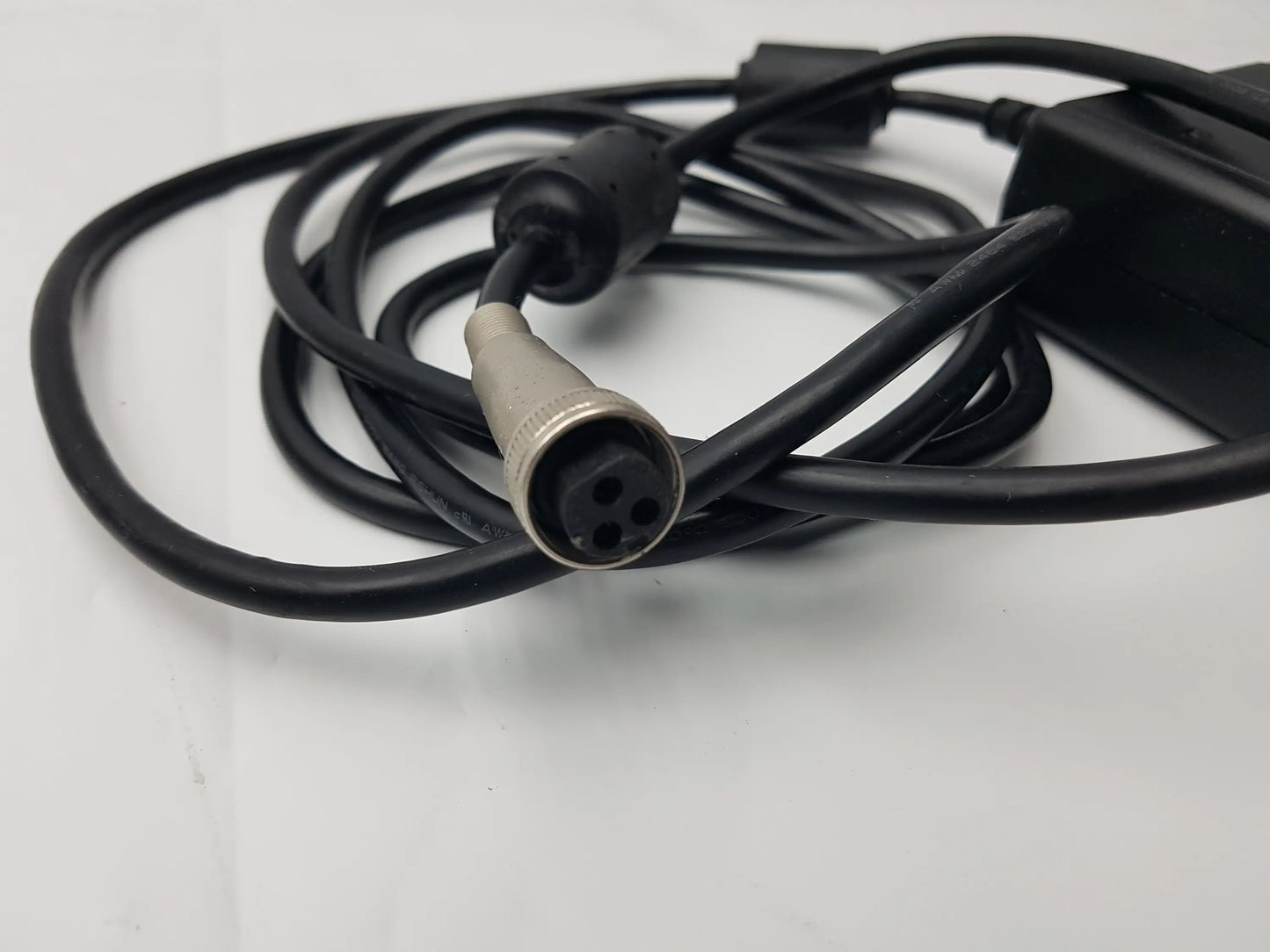 Black coiled power cable with silver 4-pin connector attached to sl power electronics mw155ra2400f02 medical power supply