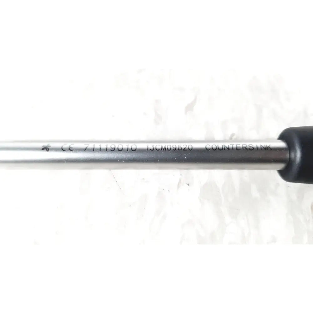 Silver stainless steel countersink screwdriver with black ergonomic handle in smith and nephew 5.5 mm cannulated screw set instrument tray