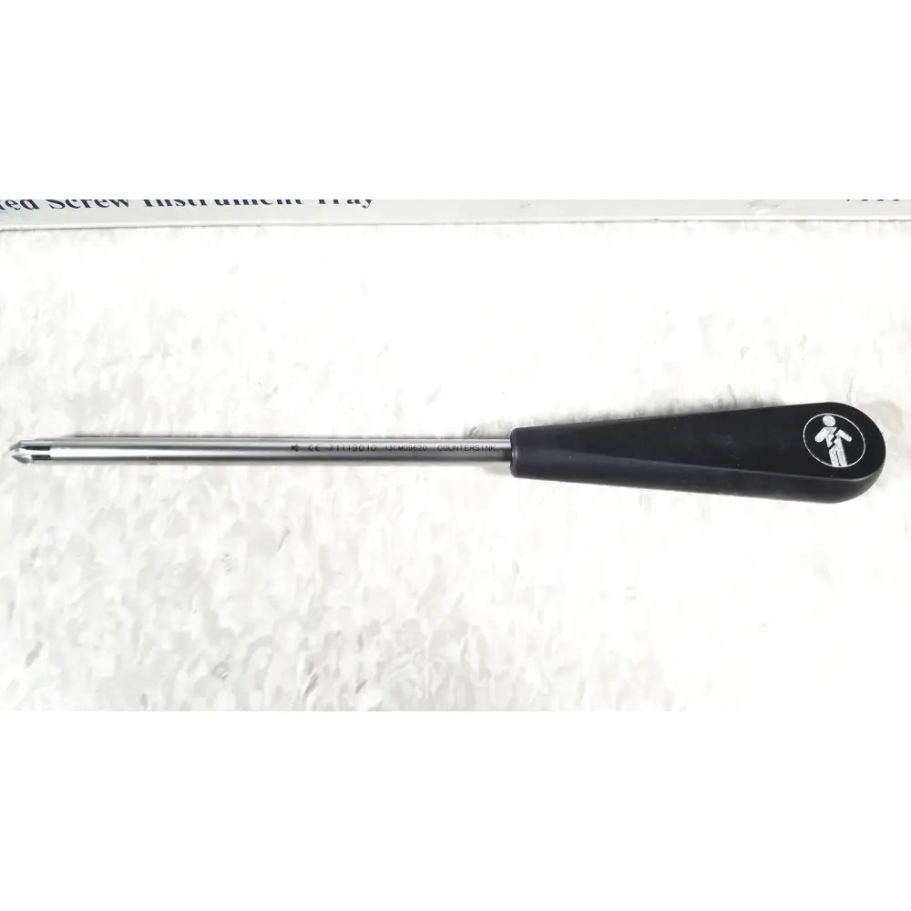 Black-handled screwdriver with metallic shaft and small white logo in smith & nephew 5.5 mm cannulated screw set instrument tray missing piece