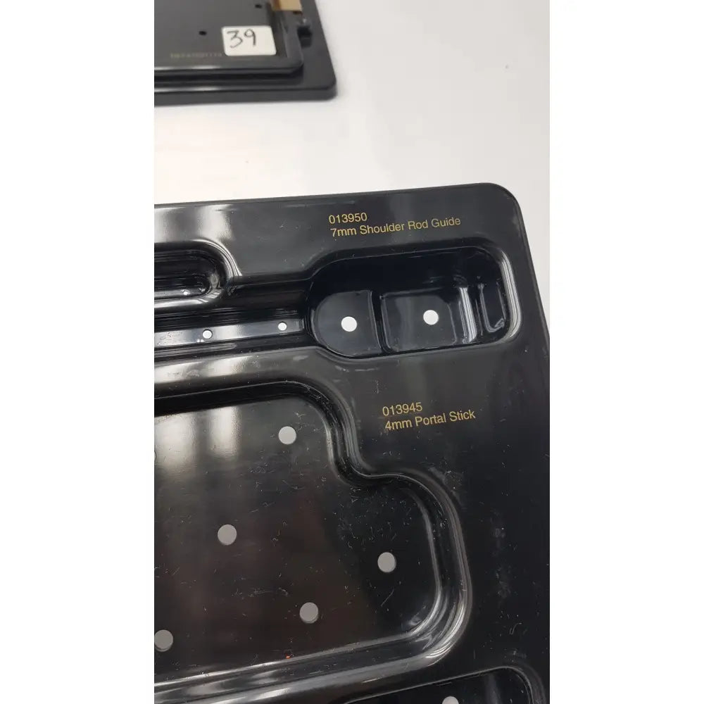 Black plastic mold with compartments for 7mm shoulder rod guide and 4mm portal stick in Smith & Nephew endoscopy portal accessory system
