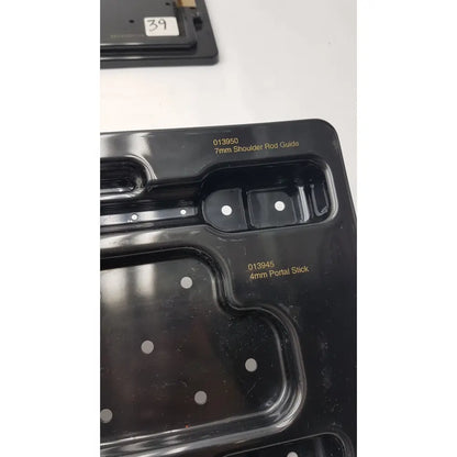 Black plastic mold with compartments for 7mm shoulder rod guide and 4mm portal stick in Smith & Nephew endoscopy portal accessory system